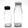 16盎司空的透明玻璃牛奶汁喝塑料盖的瓶